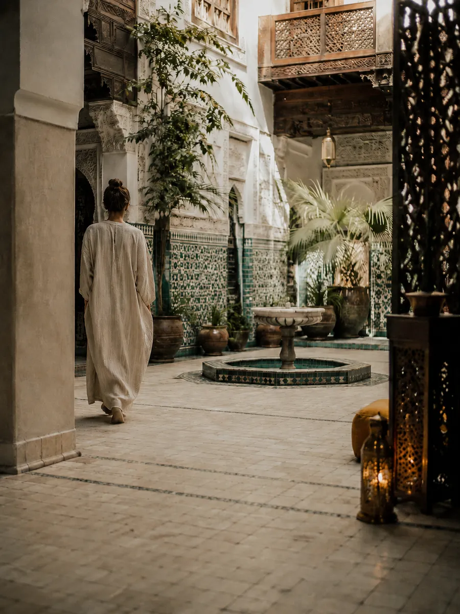 Moroccan riad courtyard with zellige fountain in morning light